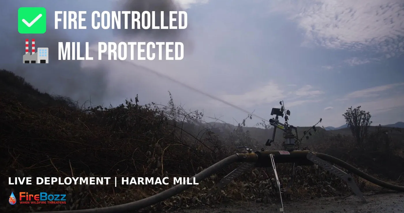 A FireBozz cannon throwing water over smoking ground at Harmac Mill